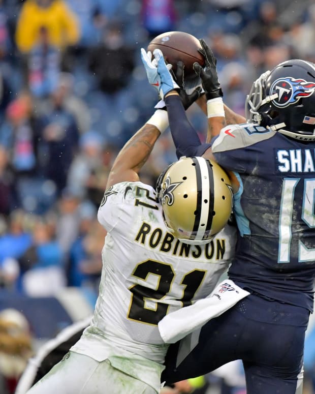 Saints Patrick Robinson prevents a touchdown by Titans Sharpe